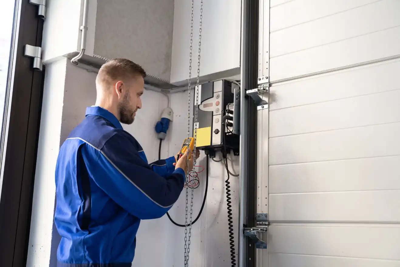 Affordable Overhead Door repair technician servicing a garage door opener
